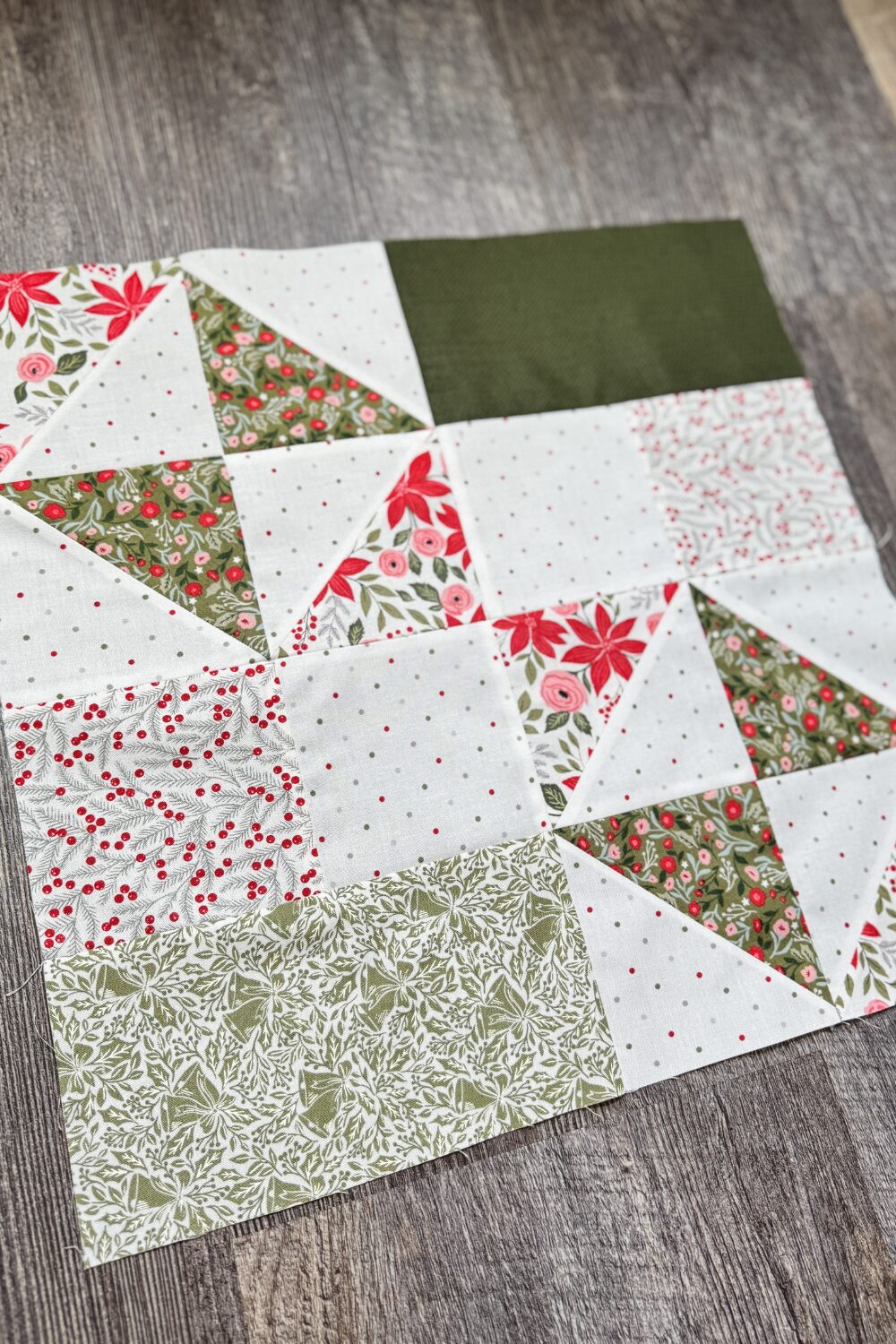 Angled overhead view of the Windflower quilt block showing piecing and fabric details from the Jolly Bar 5 Quilt Along.