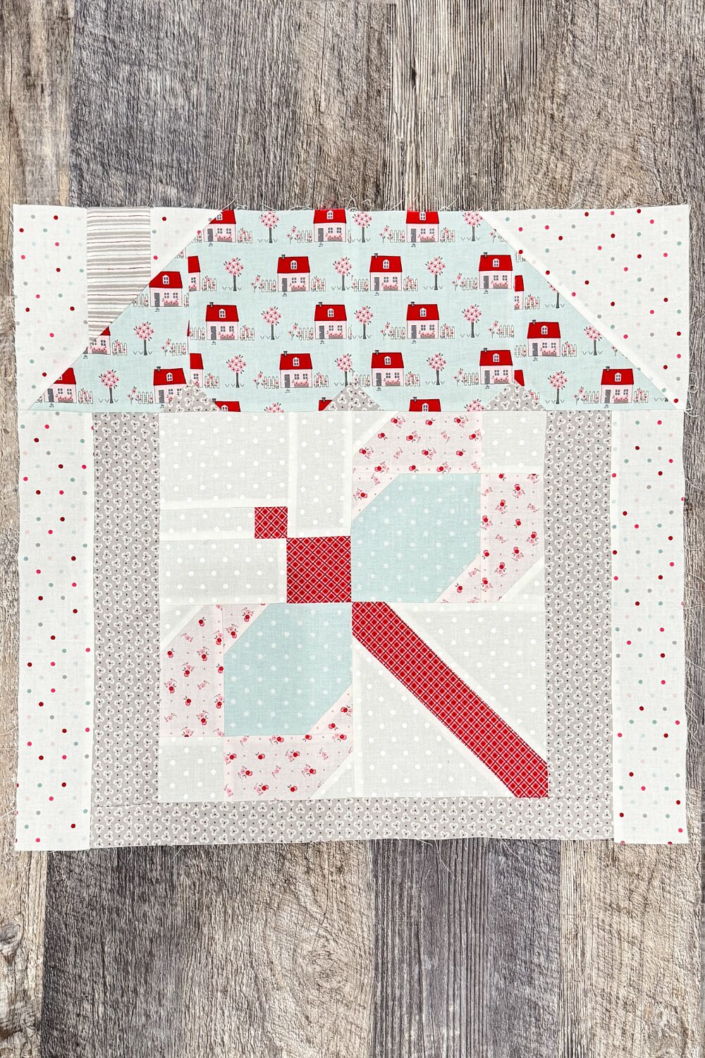 Sweet Dreams quilt block in house setting as part of the final quilt row.