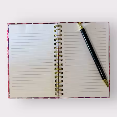 Pink, purple, and gold spiral-bound notebook with Double X quilt pattern, 4x6 inches, hardcover design with 80 lined pages and date headers.