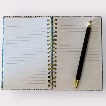 Blue spiral-bound notebook with Joe’s Coat quilt pattern in blue and gold, 4x6 inches, hardcover design with 80 lined pages and date headers.