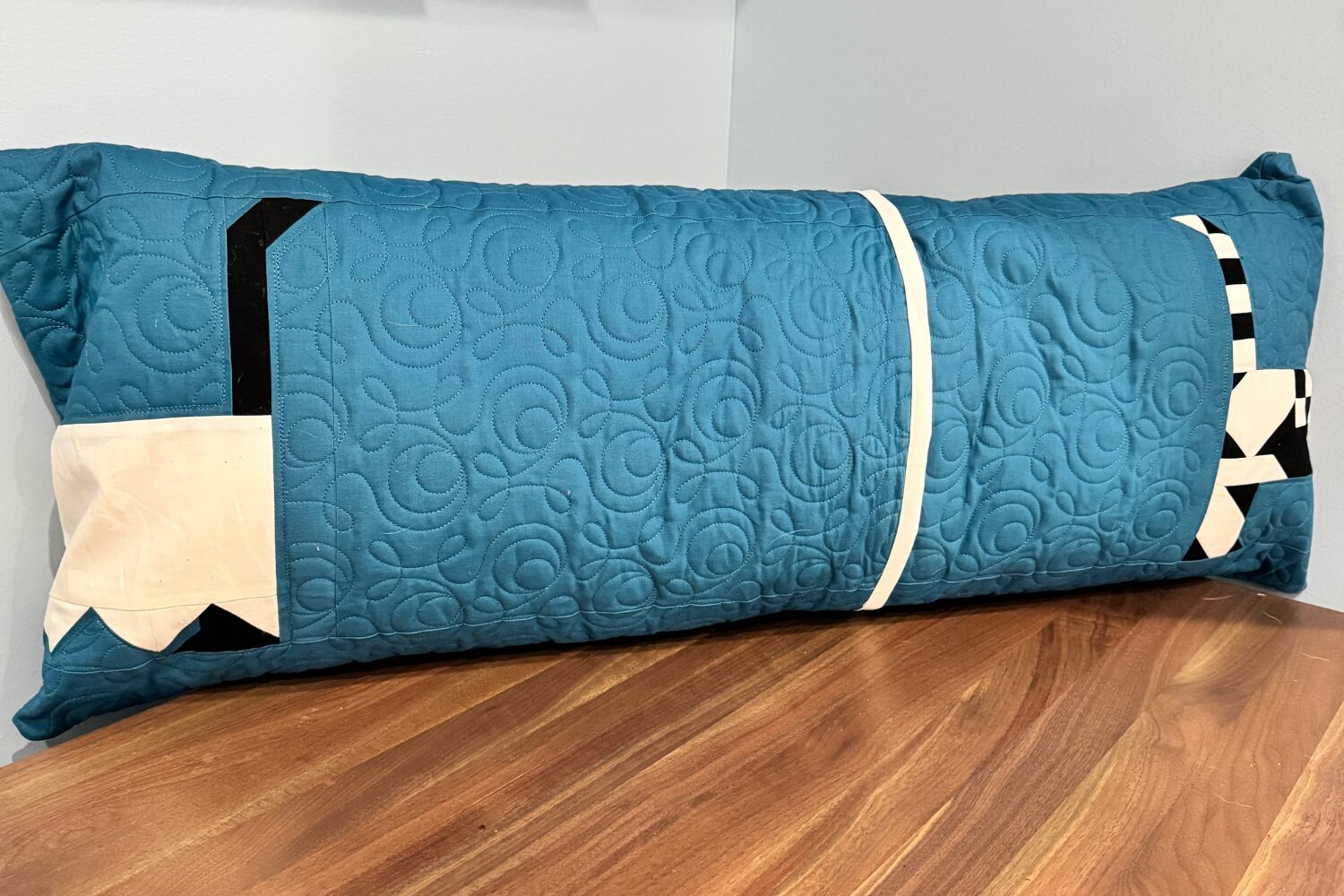 Back of Halloweenies bench pillow showing wrapped dog tails and envelope closure finished with binding.