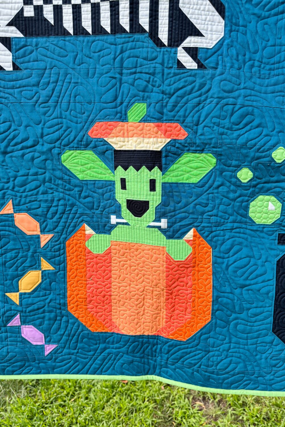 Frankenstein weiner dog from the Halloweenies Quilt popping out of a pumpkin.