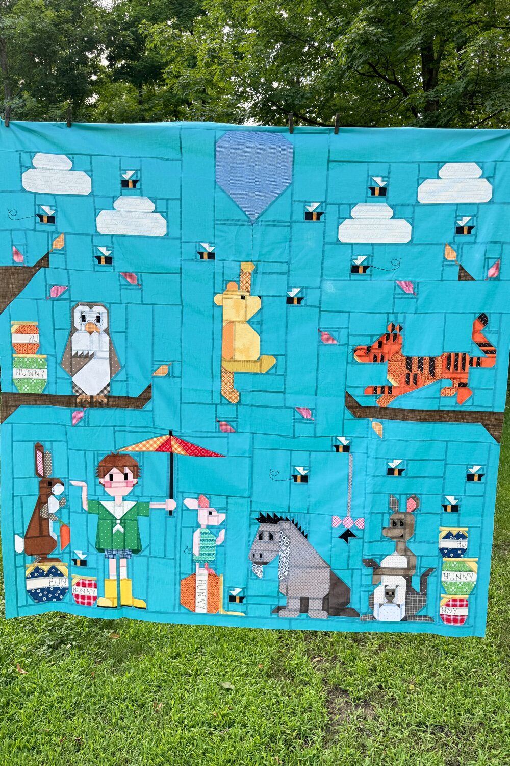 Full 100 Acre Wood quilt top with darker blue background in the original 70x70 size layout.