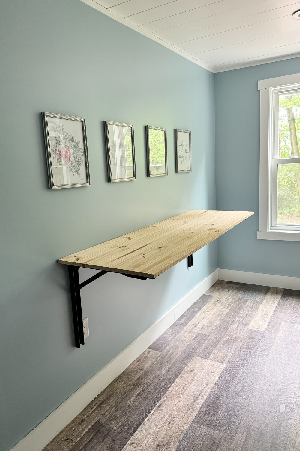 Fold-down wall-mounted countertop in a dormer workspace, used for fabric prep and blog photography.