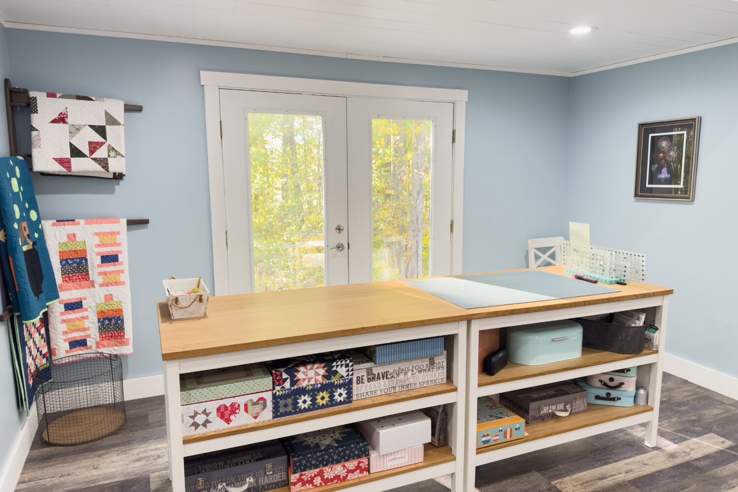 Two IKEA kitchen islands used for cutting and quilt block layout with storage shelves underneath.