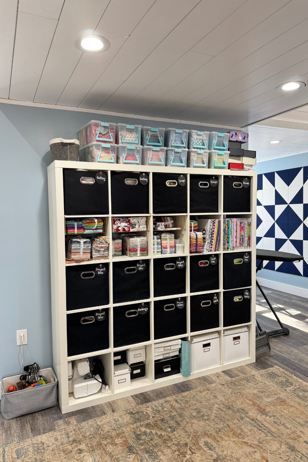 IKEA cube unit storing fat quarters, precuts, and scrap bins.