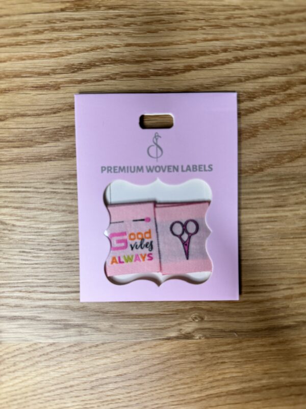 Minki Kim Good Vibes Woven Labels, set of 8 double-sided polyester labels measuring 1" x 1¼", with scissors on one side and “Good Vibes Always” text on the other.