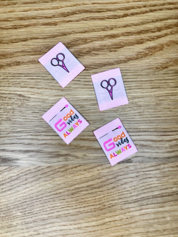 Minki Kim Good Vibes Woven Labels, set of 8 double-sided polyester labels measuring 1" x 1¼", with scissors on one side and “Good Vibes Always” text on the other.