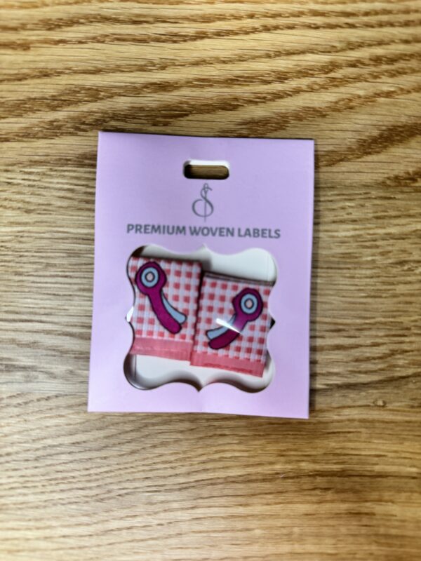 Minki Kim Rotary Cutter Woven Labels, set of 8 pre-folded polyester labels measuring 1" x 1¼", machine washable and perfect for handmade sewing projects.