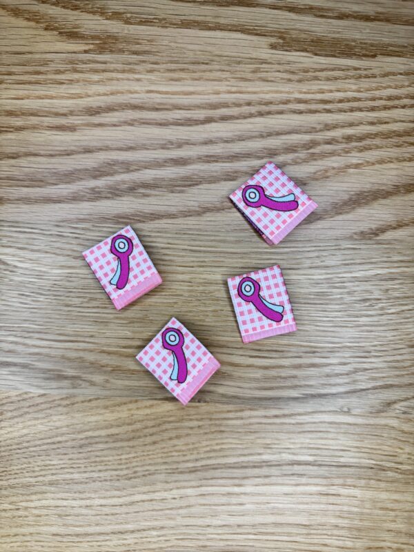 Minki Kim Rotary Cutter Woven Labels, set of 8 pre-folded polyester labels measuring 1" x 1¼", machine washable and perfect for handmade sewing projects.