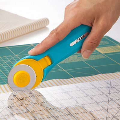 Olfa Splash Rotary Cutter in Aqua, 45mm ergonomic handle with quick-change blade system and safety guard for precise fabric cutting.