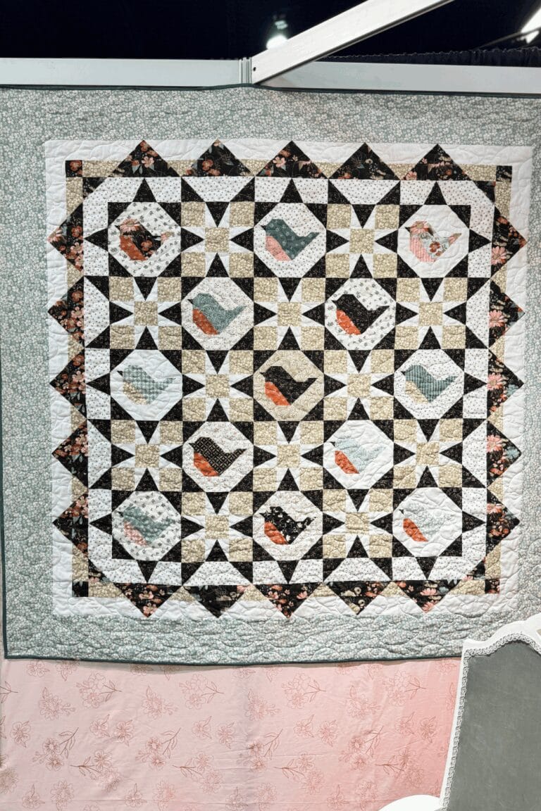 Morning Song Quilt showcasing Morning Latte fabrics at the H&H Americas show.