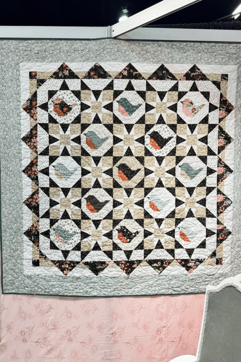 Morning Song Quilt showcasing Morning Latte fabrics at the H&H Americas show.