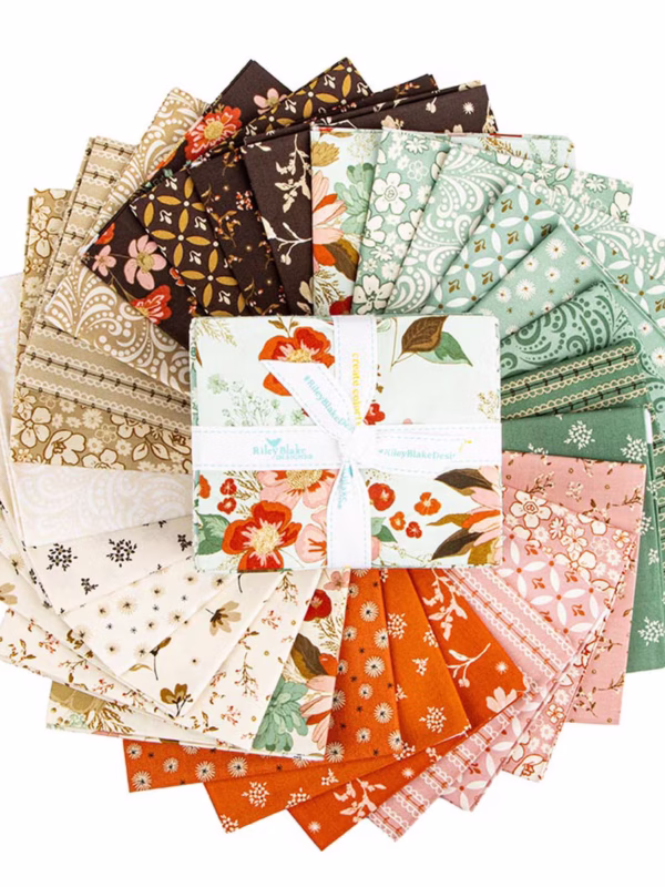 The Morning Latte Fat Quarter Bundle includes 28 fat quarters from the Morning Latte collection by Sandy Gervais for Riley Blake Designs. Each piece measures 18" x 21" and features coordinating prints in espresso, latte, pink, aloe, and spice hues — perfect for quilting and home décor projects.