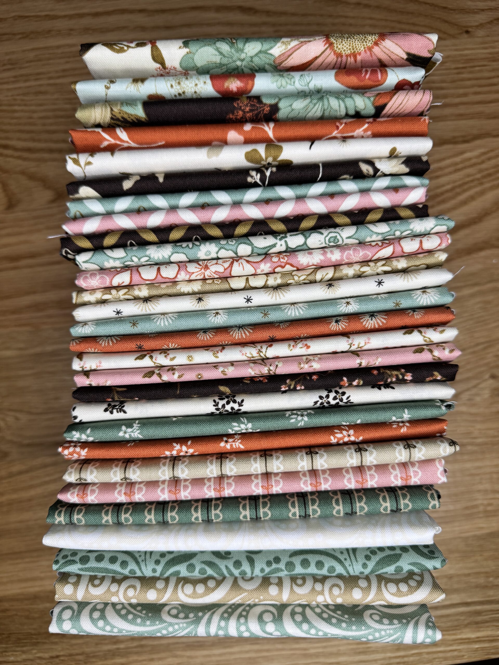 The Morning Latte Fat Quarter Bundle includes 28 fat quarters from the Morning Latte collection by Sandy Gervais for Riley Blake Designs. Each piece measures 18" x 21" and features coordinating prints in espresso, latte, pink, aloe, and spice hues — perfect for quilting and home décor projects.