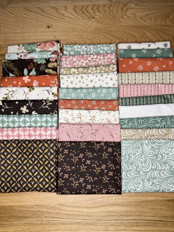 The Morning Latte Fat Quarter Bundle includes 28 fat quarters from the Morning Latte collection by Sandy Gervais for Riley Blake Designs. Each piece measures 18" x 21" and features coordinating prints in espresso, latte, pink, aloe, and spice hues — perfect for quilting and home décor projects.
