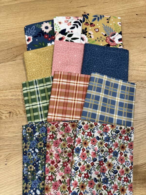 12 fat quarters from the Spoonful of Sugar fabric collection by Jennifer Long. They are a mix of plaids, florals, and blenders.