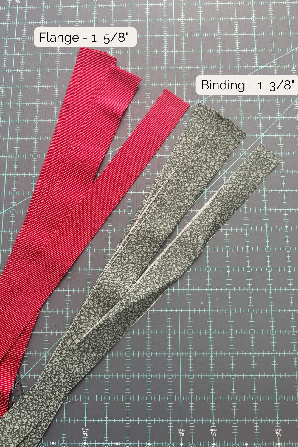 Binding fabrics cut into strips, showing the narrower 1 3/8" main binding strips and wider 1 5/8" flange strips.