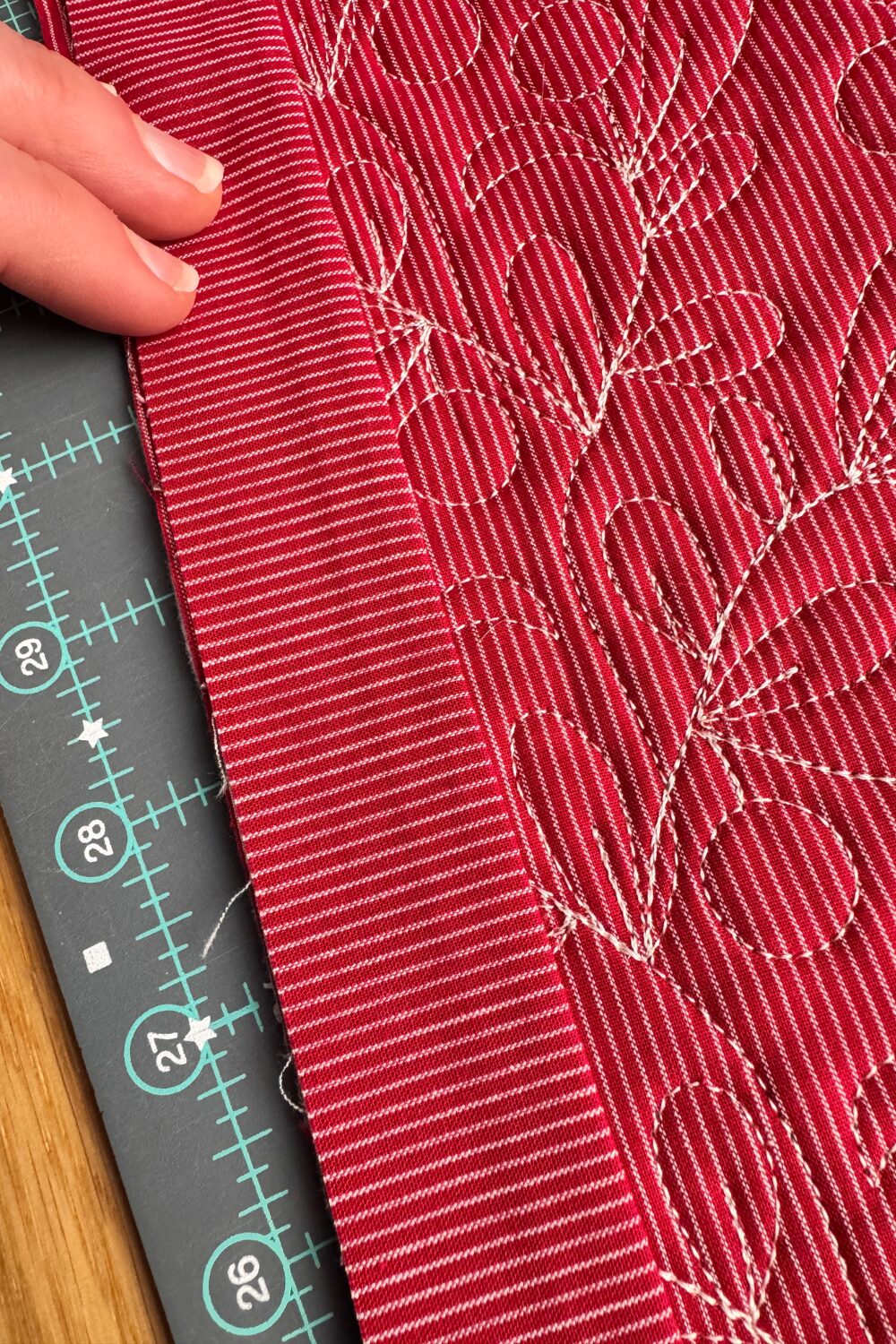 Flanged binding being sewn to the back of the quilt with a quarter-inch seam allowance.