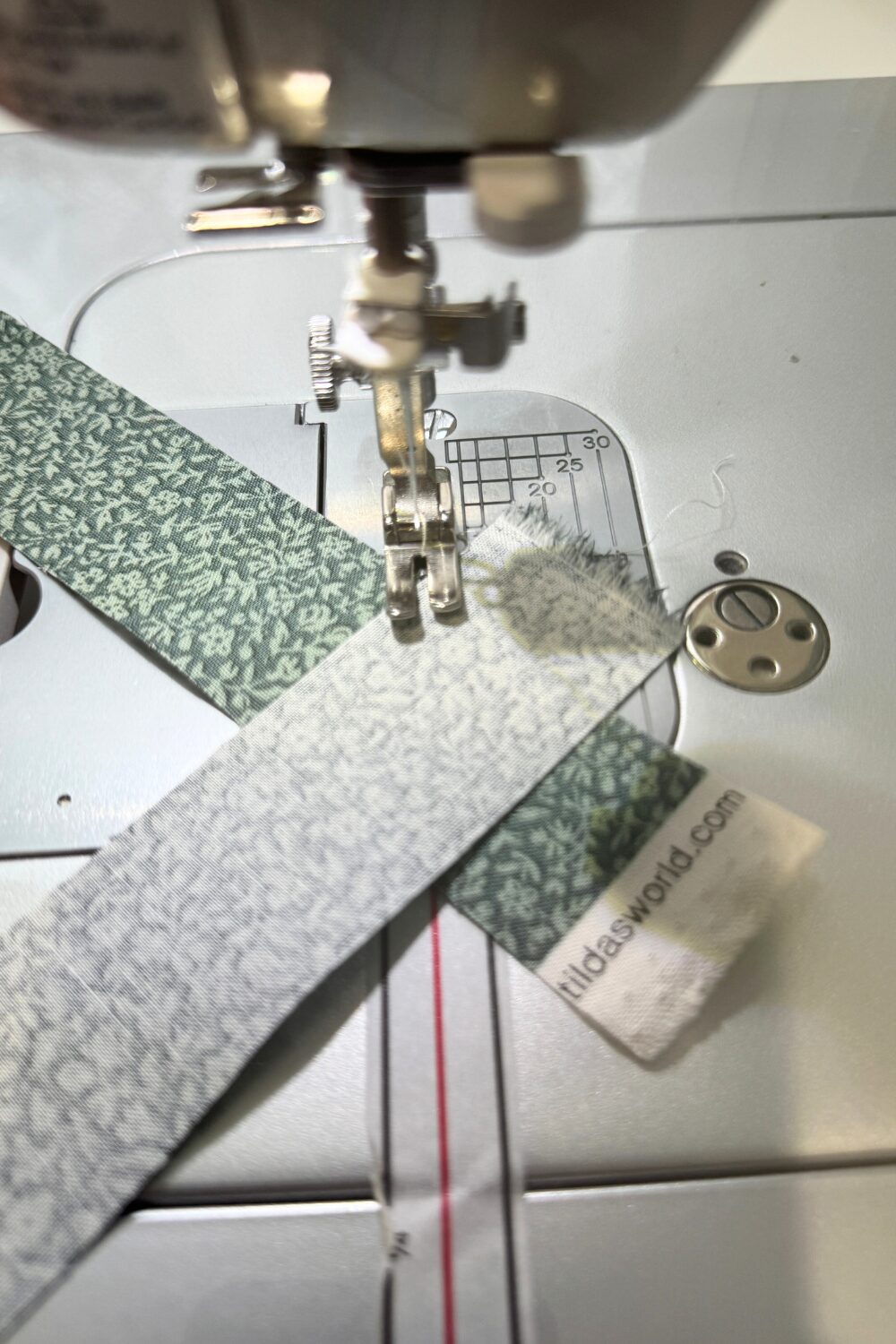 Binding strips being joined together with diagonal seams to create long continuous strips.