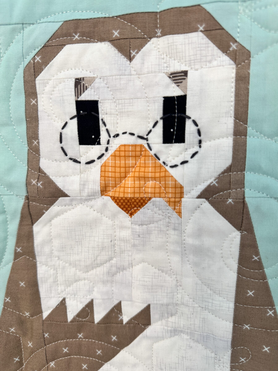Close-up of Owl quilt block with embroidered glasses on the Winnie the Pooh quilt.
