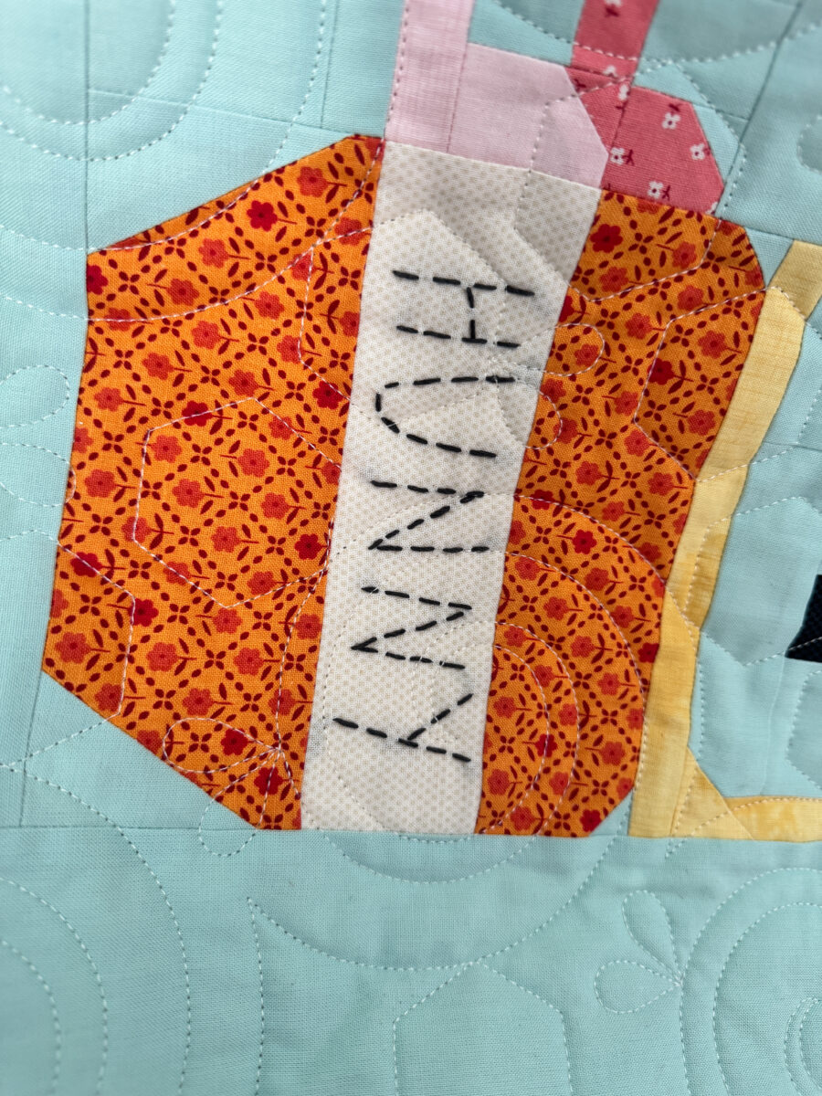 Close-up of embroidered Hunny pot on the Winnie the Pooh quilt.