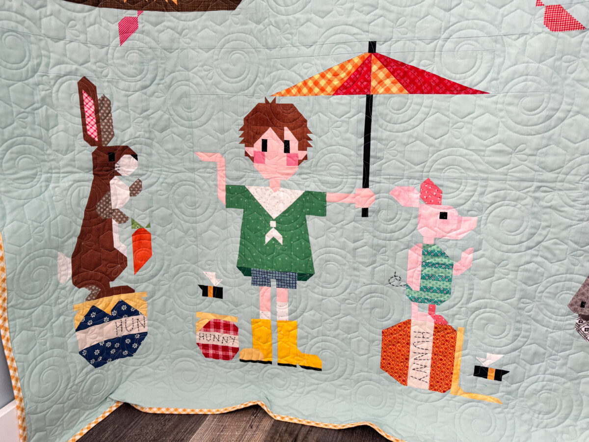 Close-up of Rabbit, Christopher Robin, and Piglet quilt blocks on the Winnie the Pooh quilt.