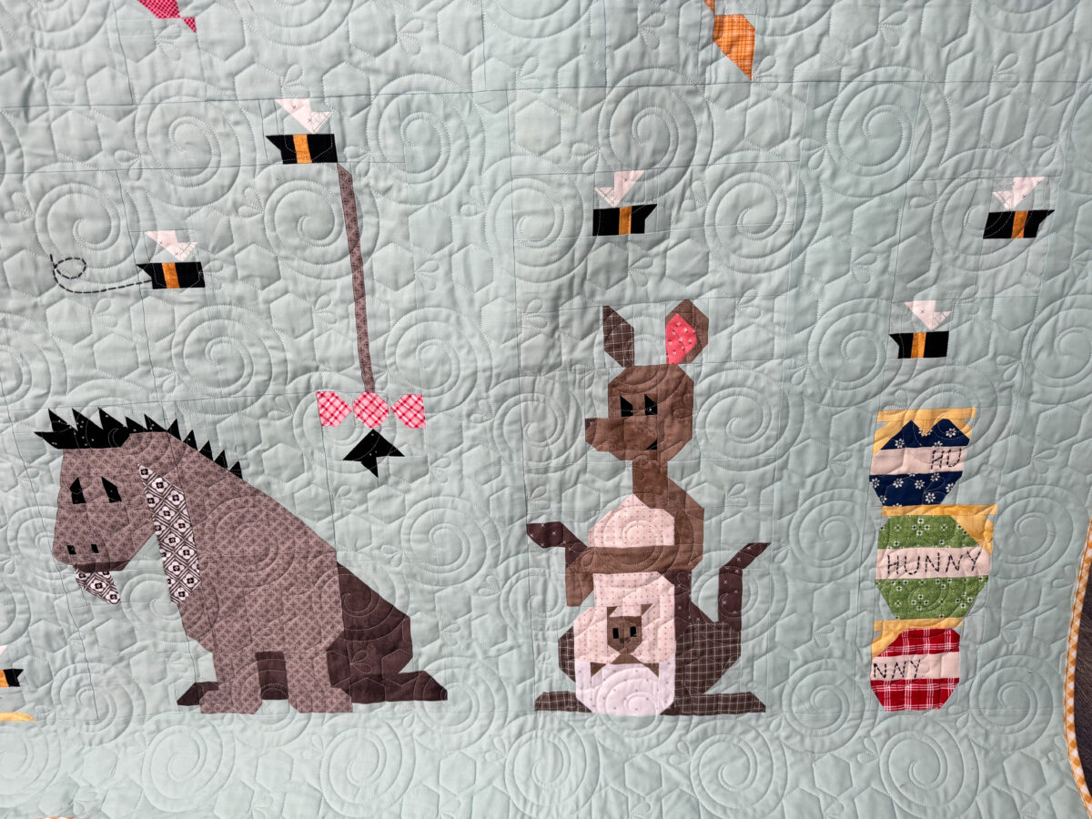 Close-up of Eeyore and Kanga and Roo quilt blocks on the Winnie the Pooh quilt.