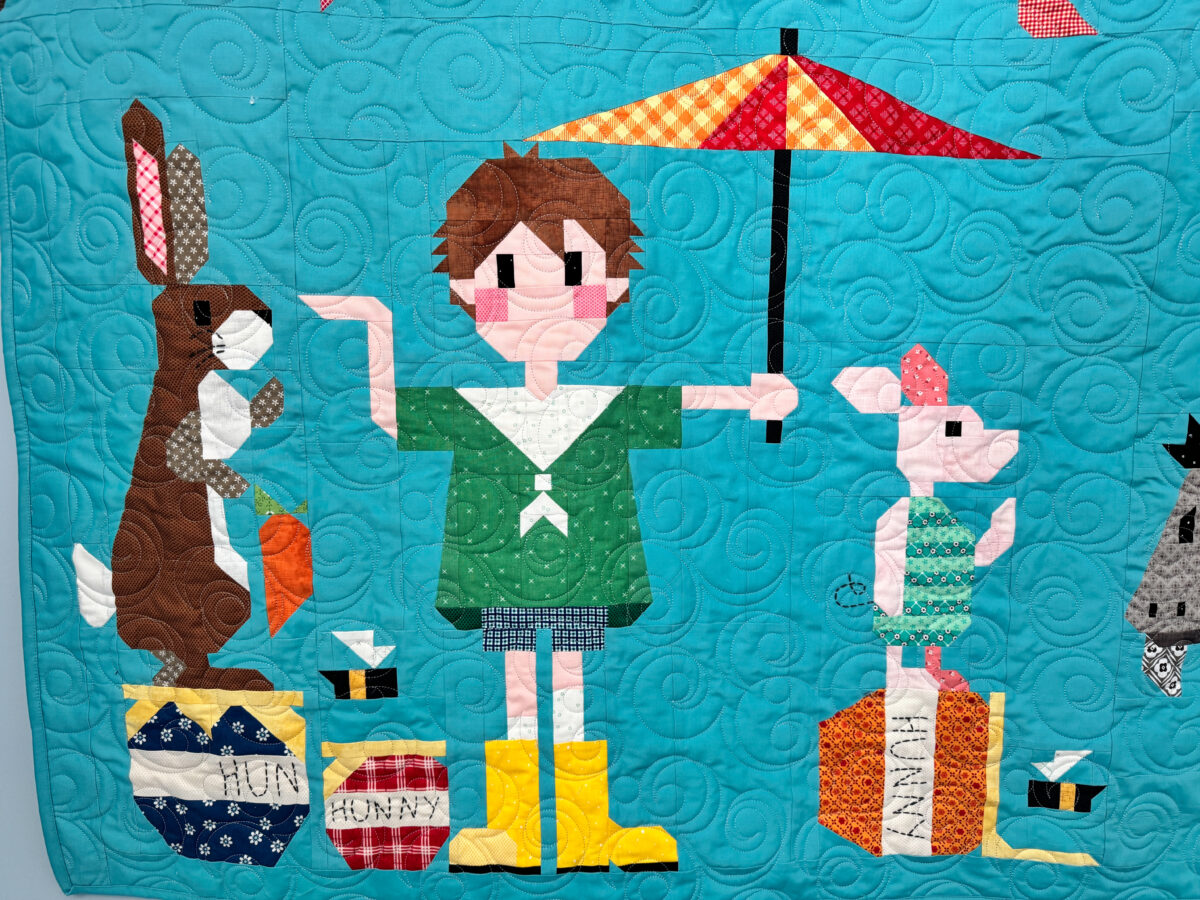 Close-up of Rabbit, Christopher Robin, and Piglet quilt blocks on the Winnie the Pooh quilt.