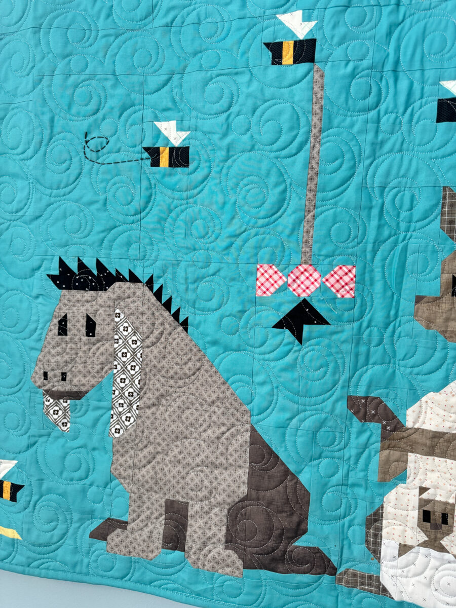 Close-up of Eeyore and Kanga and Roo quilt blocks on the Winnie the Pooh quilt.