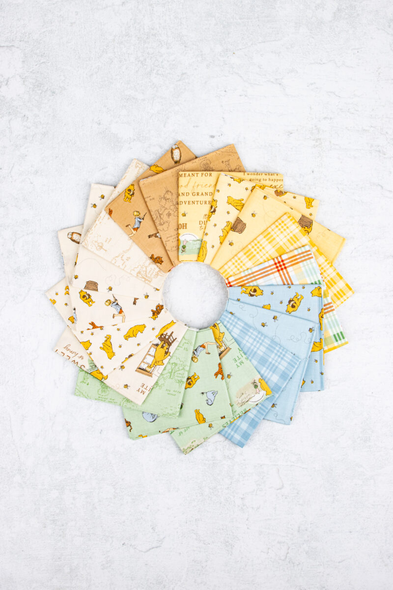 Winnie the Pooh fat quarter bundle featuring 18 coordinating prints by Echo Park for Riley Blake Designs.