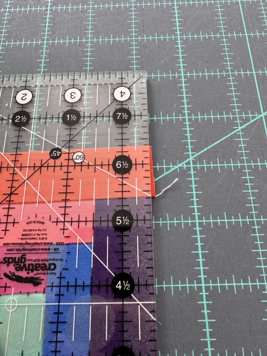 Cutting off excess length of a quilt block to make it square