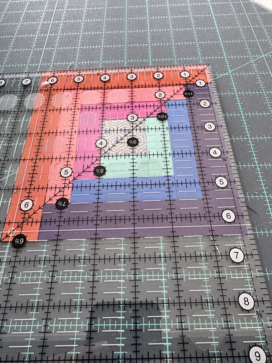 Measuring the unfinished size of a quilt block.  This block measures 6.5"