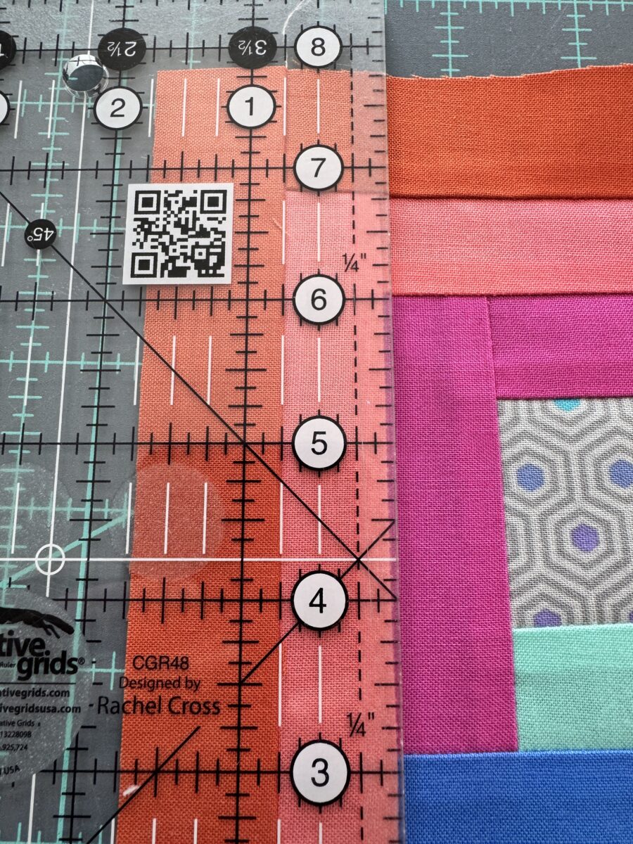 A strip of a log cabin quilt block measuring too small resulting in the whole block being slight too small.