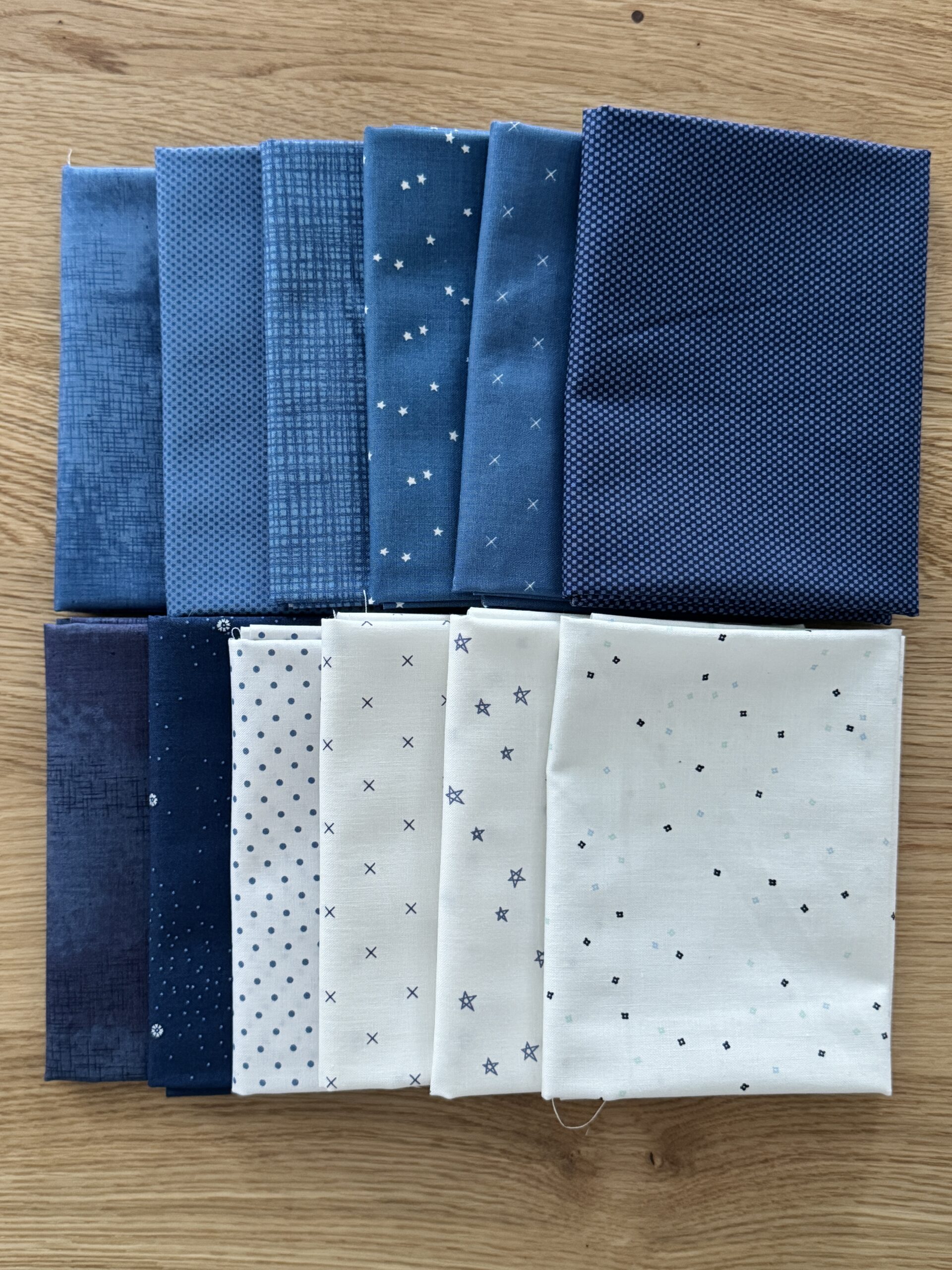 Snowbound Seasonal Basics fat quarter bundle arranged in two rows showing blue and navy Riley Blake Basics