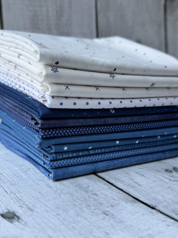 Stacked Snowbound Seasonal Basics fat quarter bundle with blue and white Riley Blake Basics