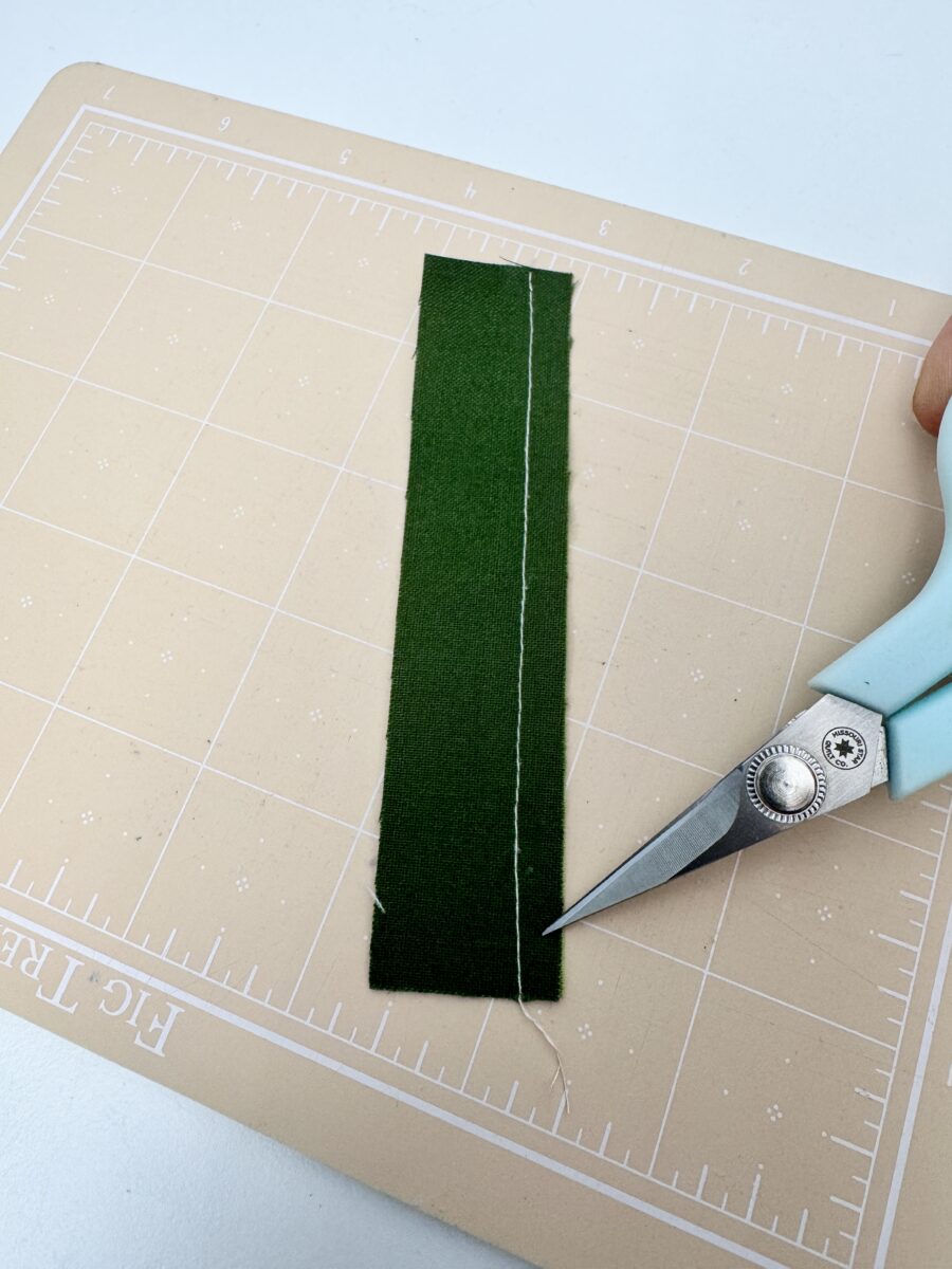 1/4 inch seam not accurate due to drifting at the end of the seam. The white thread veers narrower at the end of the green fabric.