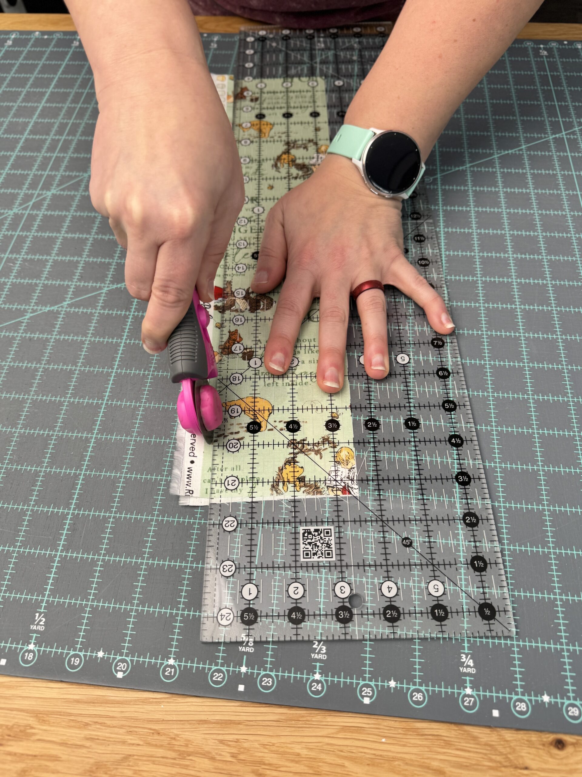 Advancing hands forward on a long strip of fabric while cutting with a rotary cutter increases accurate cutting for quilting