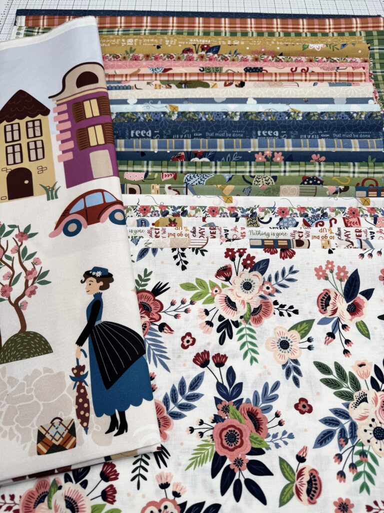 Flat Lay of Spoonful of Sugar fabrics and panel for the Cherry Tree Lane Panel Quilt Along