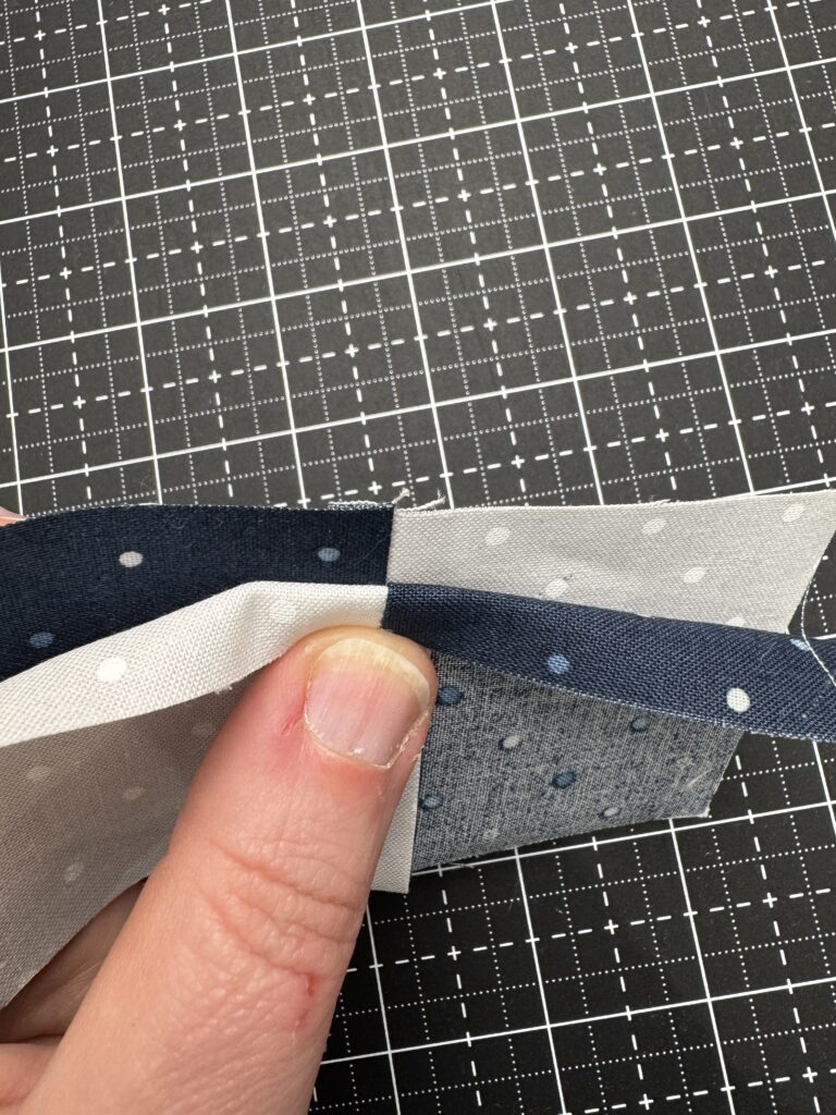 Two four patch units with one folded back to show how to nest seams