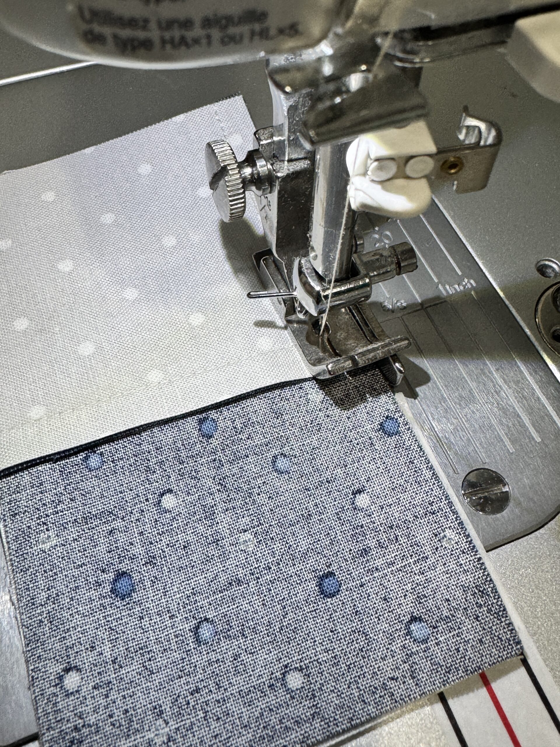 Four patch unit under the sewing machine needle at the point where the nested seams meet