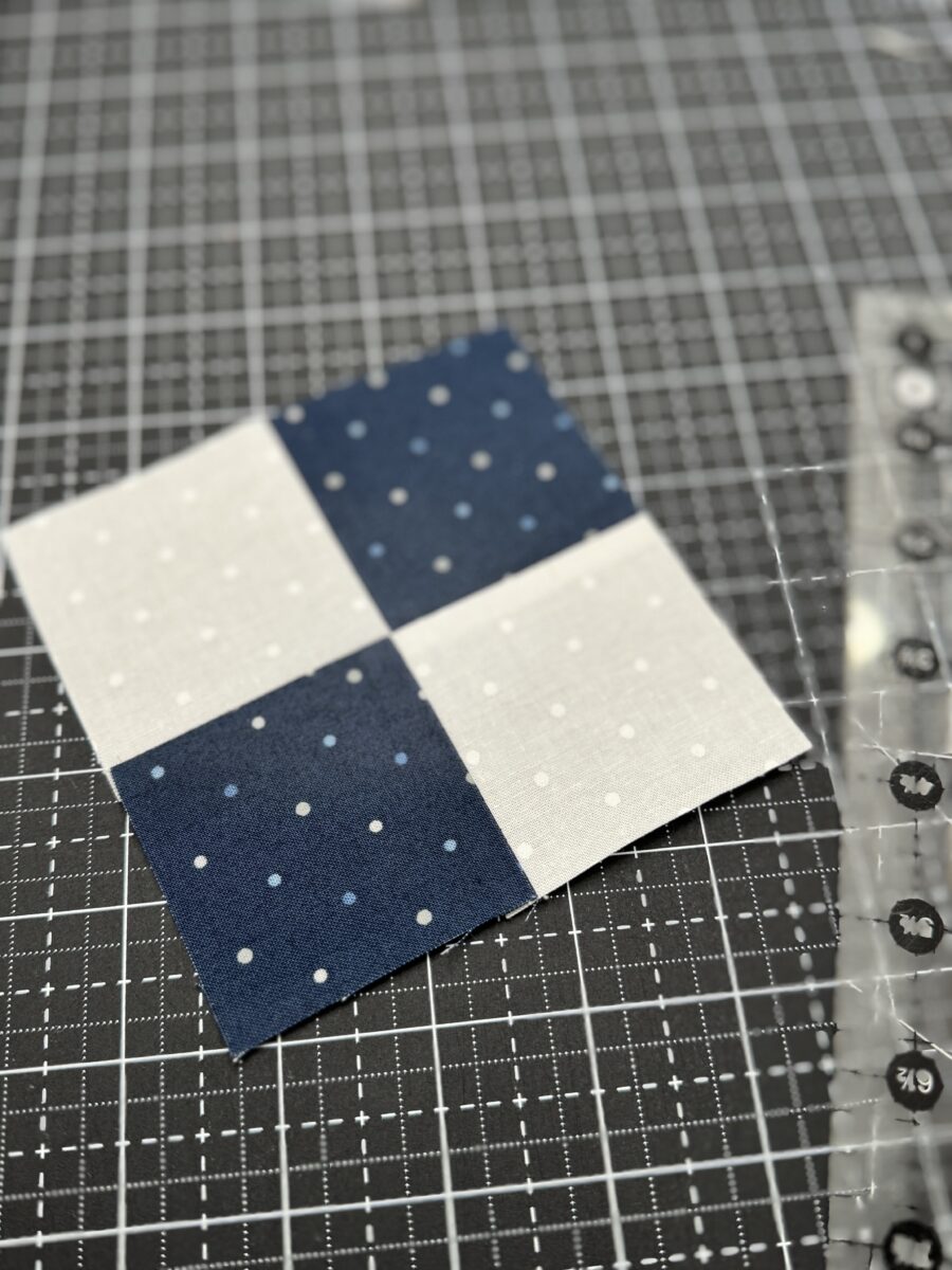 Completed four patch unit using nested seams pressed open with a sharp, perfectly aligned center intersection