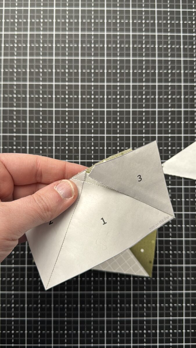 Removing foundation paper from stitched flying geese quilt unit