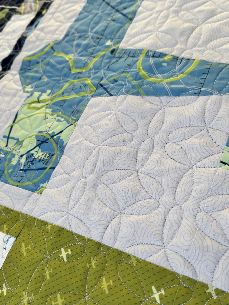 Close-up of Propel pantograph quilting stitched across the Aviator airplane quilt