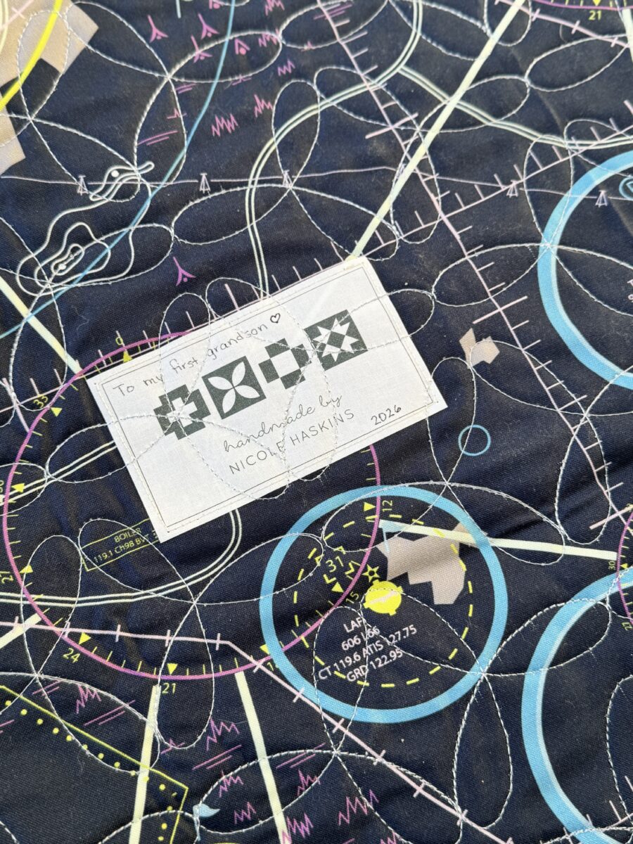Close-up angled view of blue airplane quilt block from Aviator pattern made with High Flight fabric