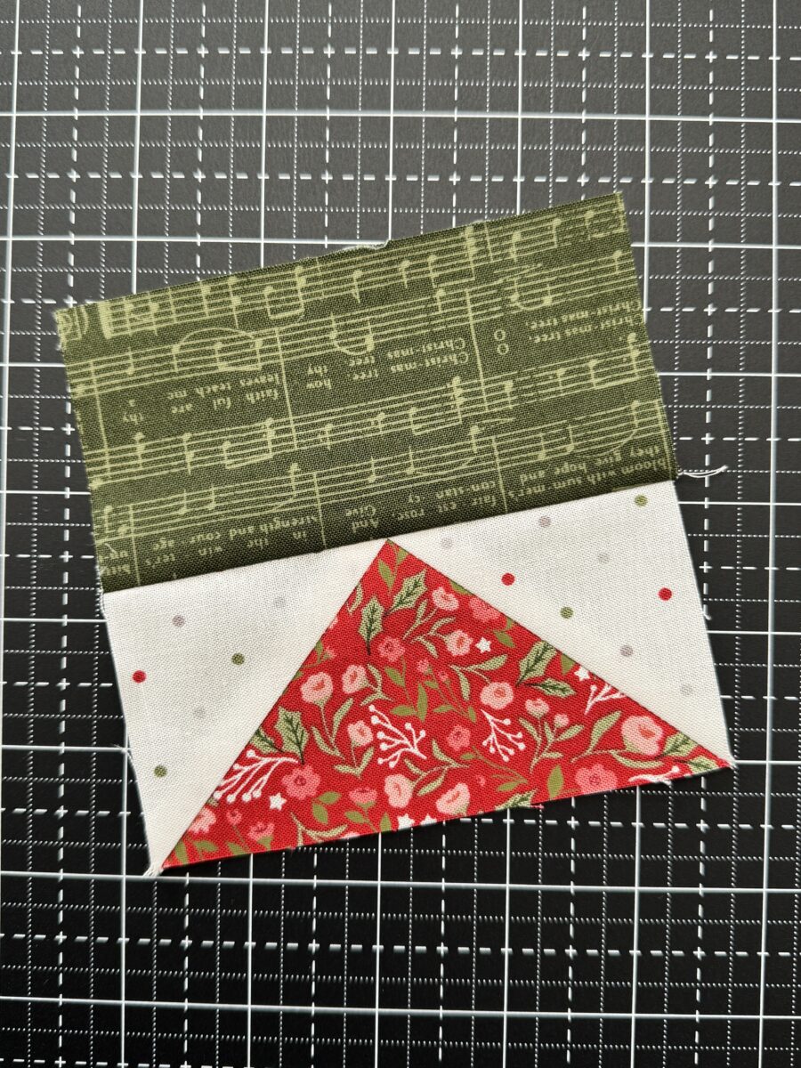 Flying geese unit sewn to a rectangle with a sharp, intact triangle point