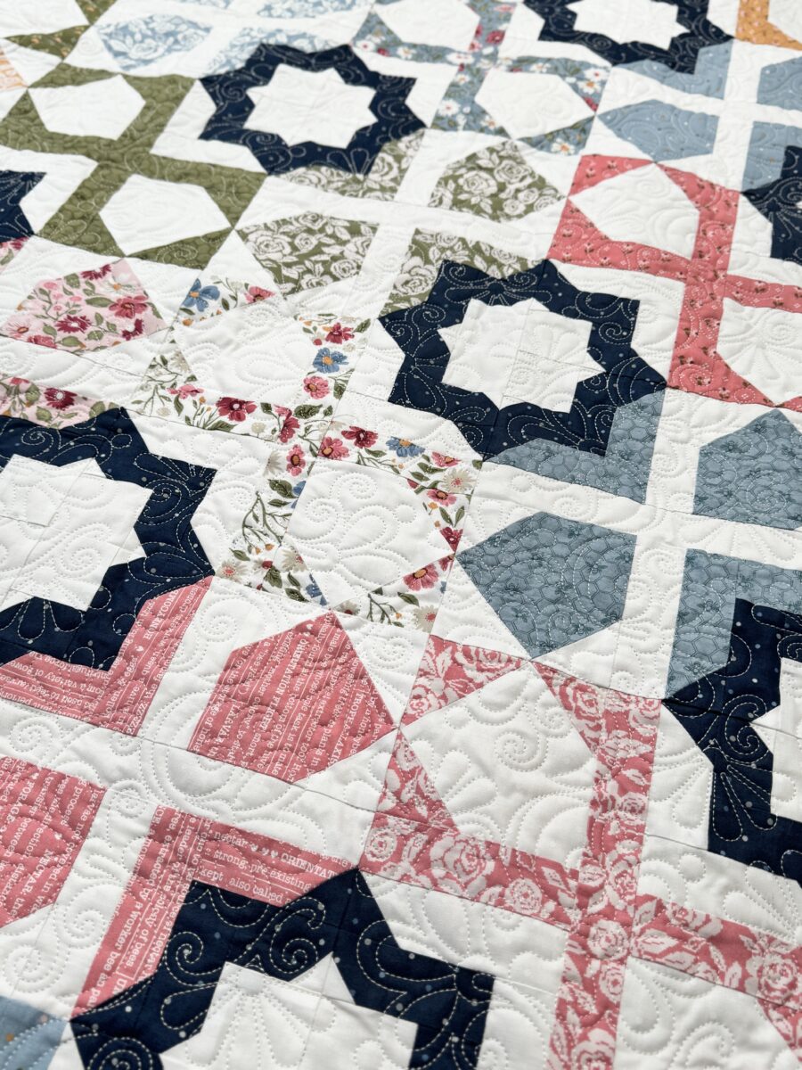Detail photo of navy blue accent star in the Dreamer quilt made with Wild Honey fabrics.