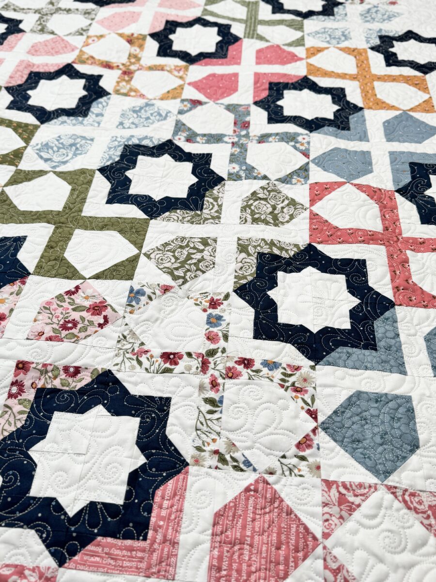 Close-up of geometric patchwork in Dreamer quilt using Wild Honey fabric collection.