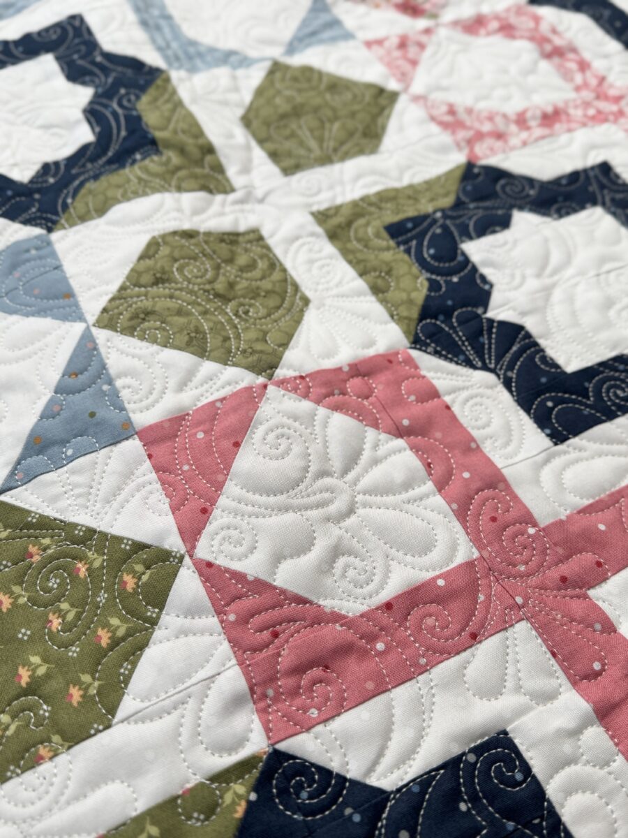 Close-up of geometric patchwork in Dreamer quilt using Wild Honey fabric collection.