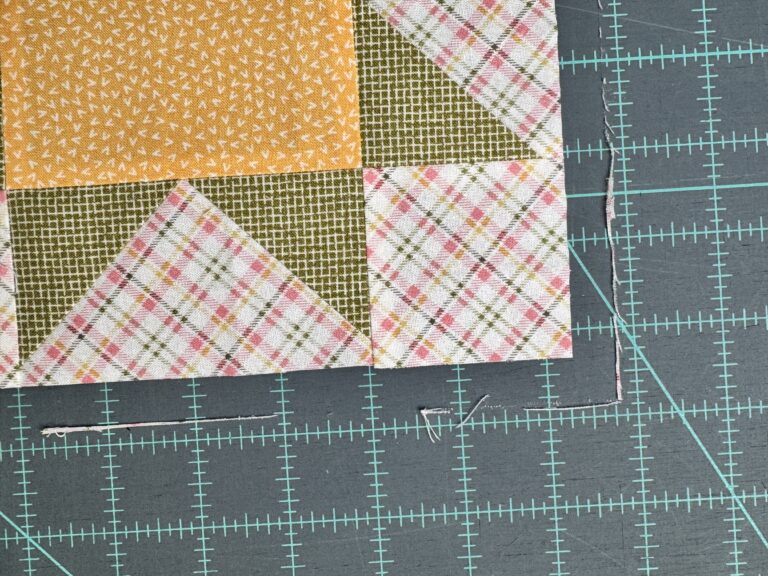 Small amounts of fabric trimmed from two sides 90 degrees from each other to square up the quilt block
